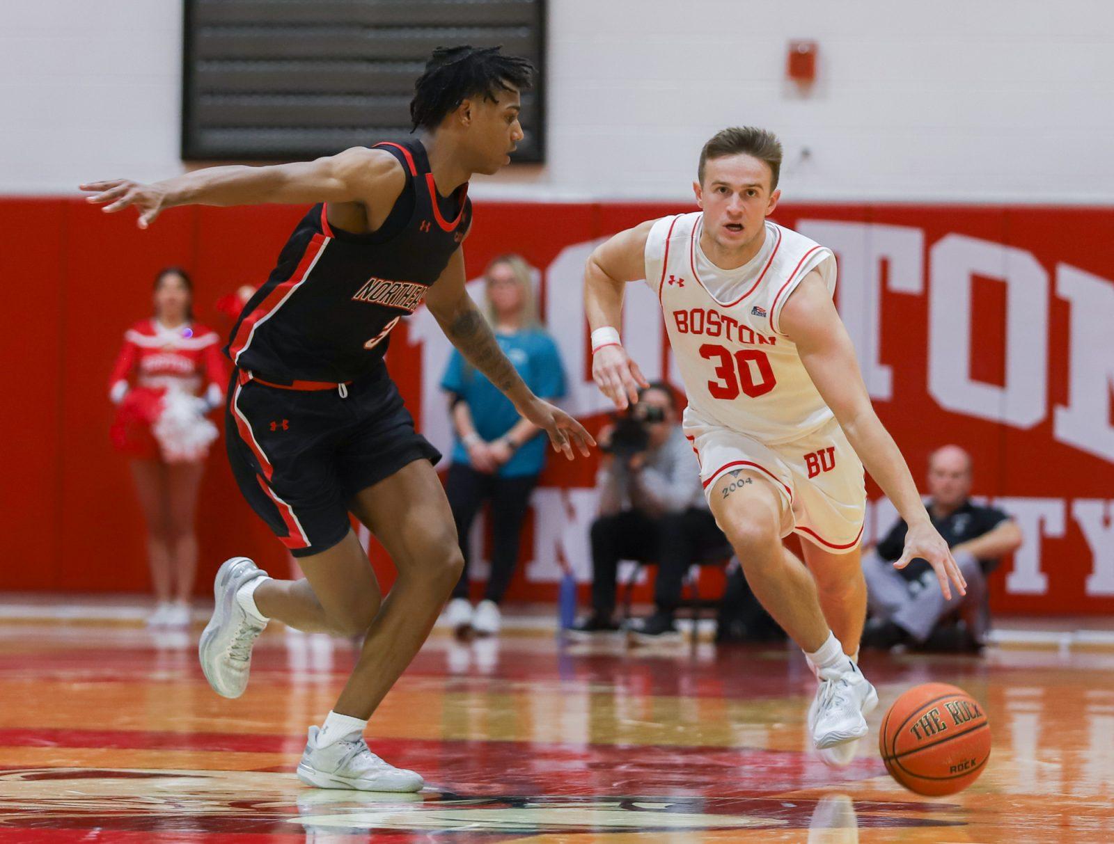 Junior guard Ben Roy (30) dribbles the ball down the court during the game on Monday. The Boston University men’s basketball team lost to the Northeastern University Huskies on Monday. KATE KOTLYAR/DFP PHOTOGRAPHER 
