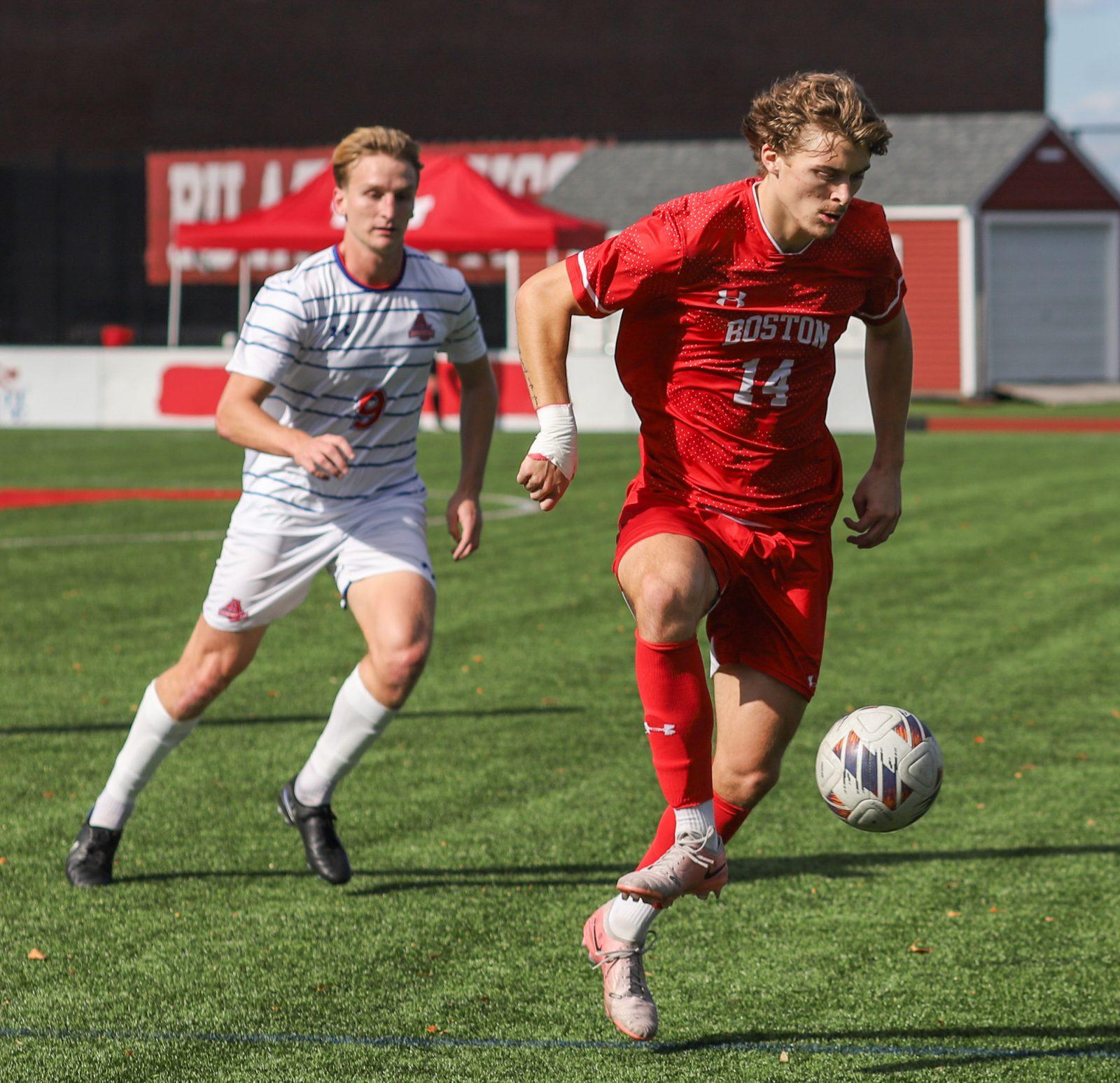 Junior defender Quin DeLaMater (14) controls the ball during a game against American University on Oct. 26. The men’s soccer team lost to Colgate University in the Patriot League tournament semifinal on Tuesday. KATE KOTLYAR/DFP PHOTOGRAPHER