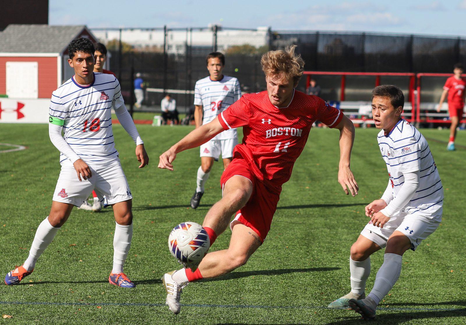 Boston University senior forward Andrew Rent (11) works around opponents during a game against American University on Friday. BU and American tied 2-2 on Friday. KATE KOTLYAR/DFP PHOTOGRAPHER