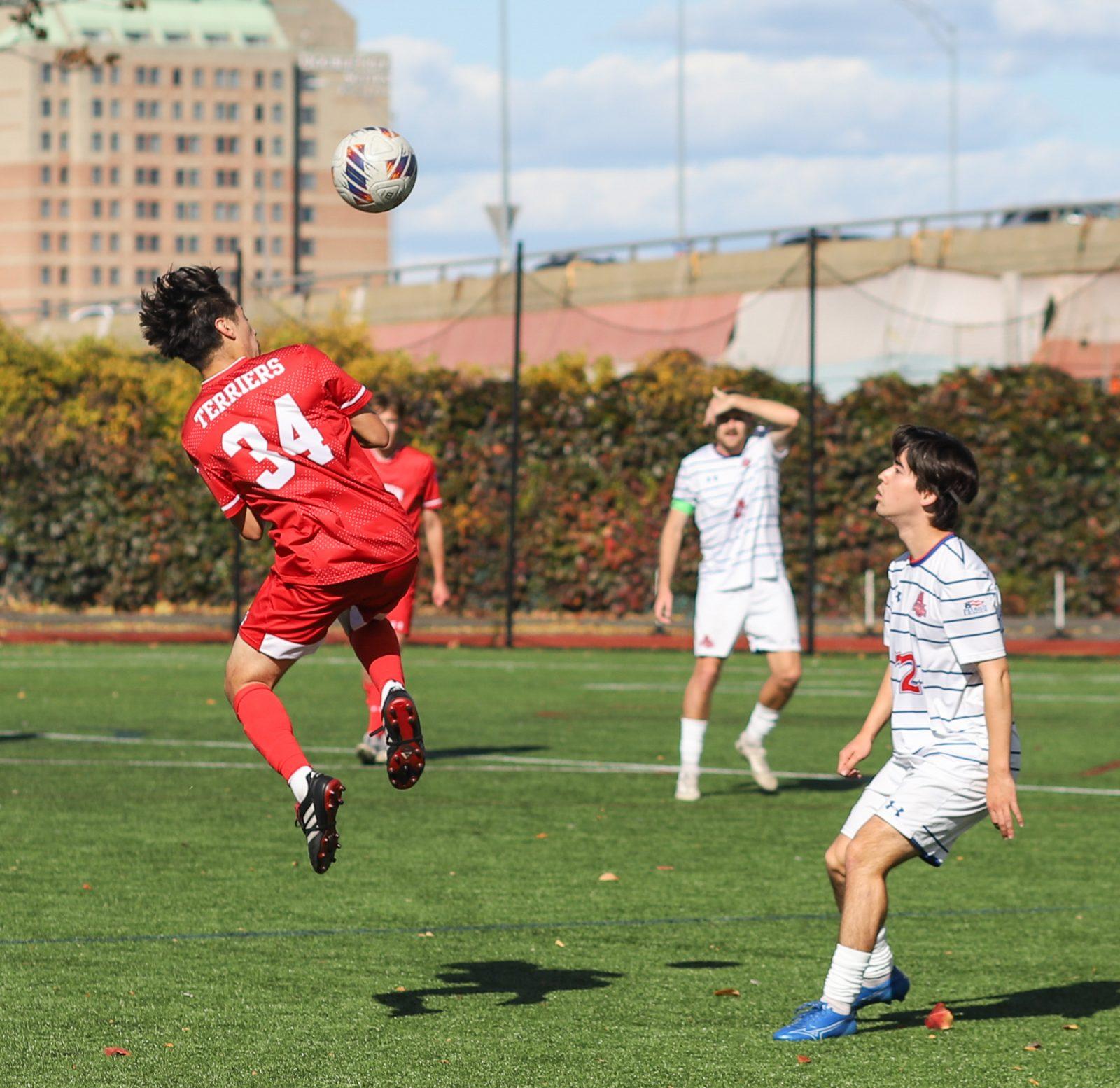 Senior midfielder Kevin Torres (34) jumps for a header at a men’s soccer game against American University on Oct. 26. The Boston University men’s soccer team secured the Patriot League regular season championship and earned a first-round bye in the tournament. KATE KOTLYAR/DFP PHOTOGRAPHER
