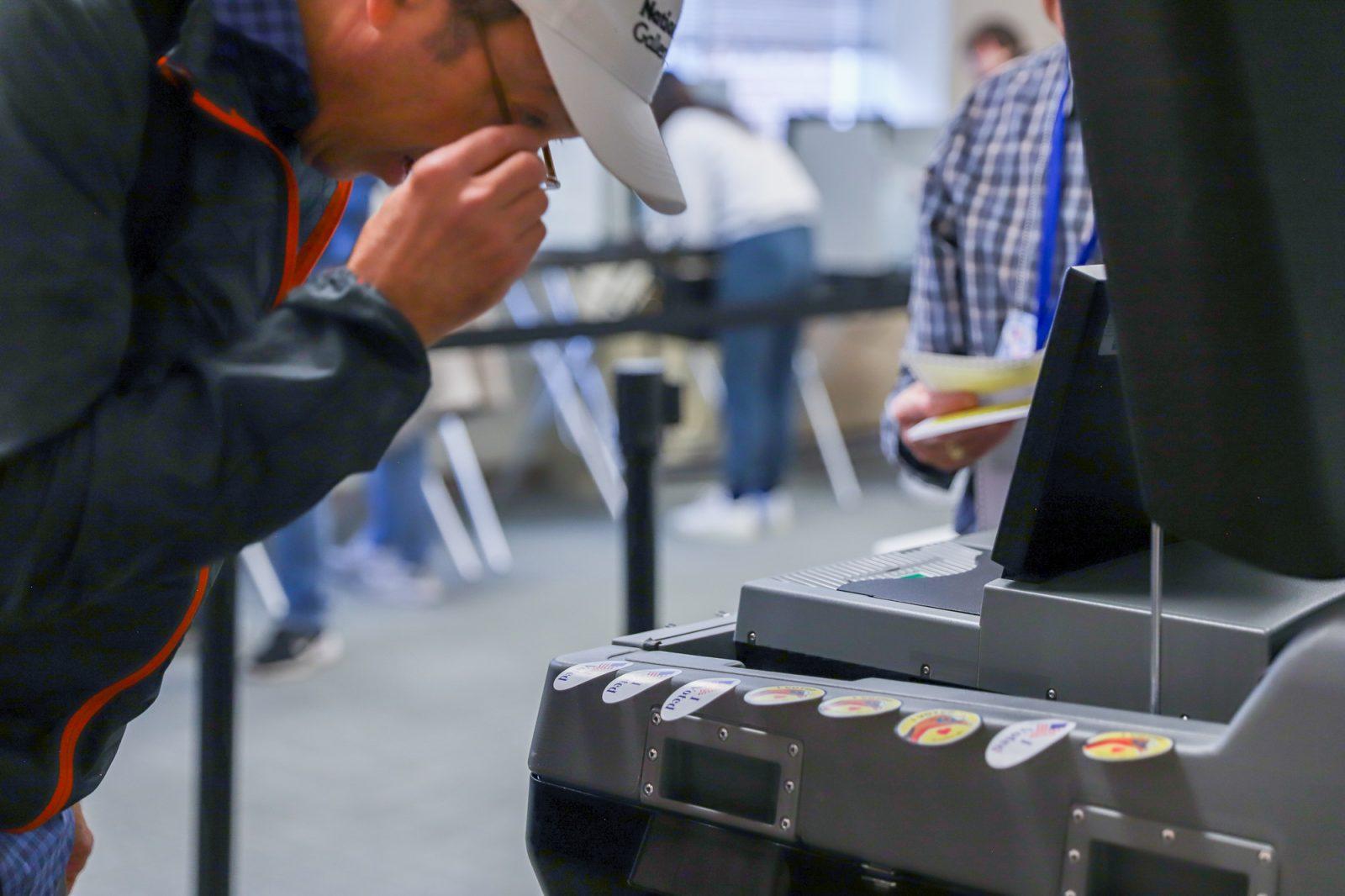 A voter looks at “I voted” stickers at the Brookline polling station. Policy stance and Latino identity were the most influential factors to sway Latino voters in the 2024 Presidential Election. KATE KOTLYAR/DFP PHOTOGRAPHER