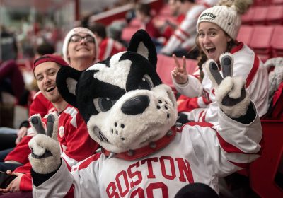 BU mascot posing for the camera at a hockey game