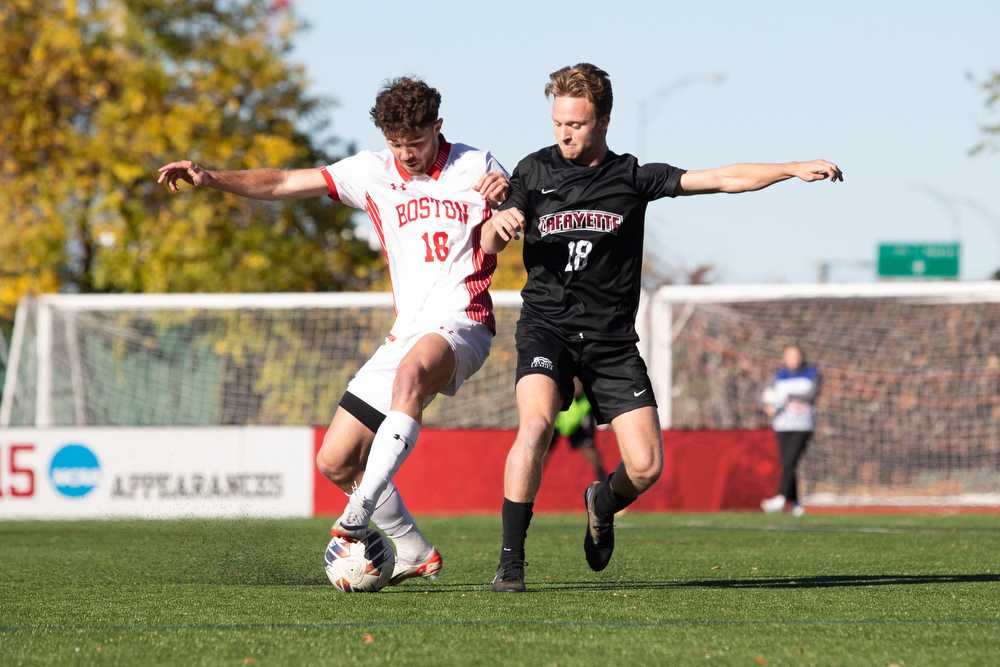 Boston University sophomore defender John Roman works the ball around Lafayette junior midfielder Carter Houlihan during the Patriot League Championship game on Saturday. The Terriers clinched the Championship, beating Lafayette 1-0. HALEY ALVAREZ-LAUTO/DFP PHOTOGRAPHER