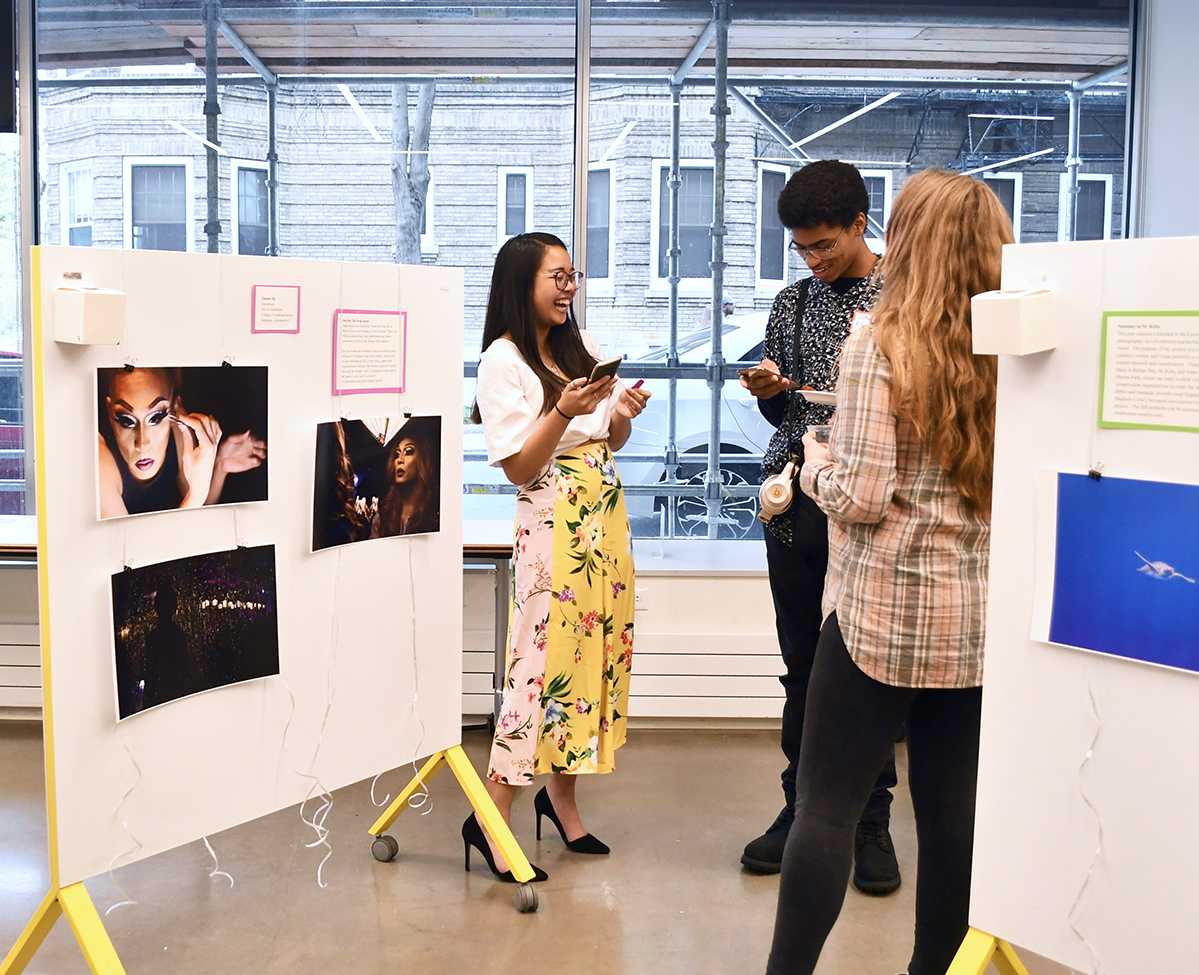 People talk at the I.M.P.A.C.T. Film and Art Festival held at the BU BUild Lab on April 25. The event featured a student gallery, live performances and a late-night screening of the film “Meow Wolf.” AUSMA PALMER/ DFP STAFF
