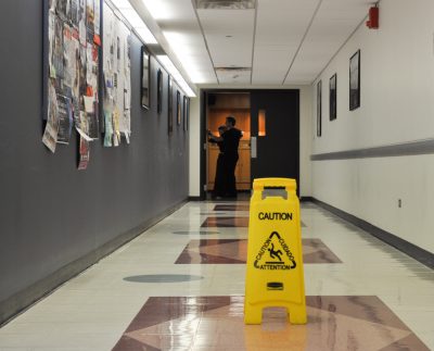A caution wet floor sign in the middle of a hallway