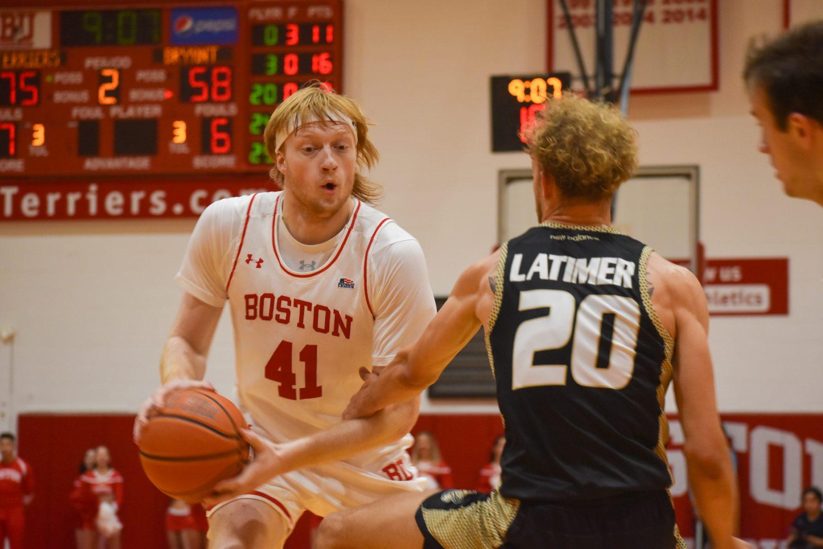 Boston University sophomore forward Otto Landrum (41) looks to get around Bryant 5th year guard Miles Latimer (20) during a game on Thursday. The Terriers won 95-79. KELLY BRODER/DFP PHOTOGRAPHER