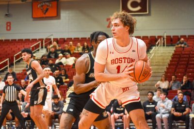 Sophomore forward Nico Nobili (14) looks to a Terrier before passing the ball during a Nov. 16 game against Bryant. The team has six games over winter break. KELLY BRODER/DFP PHOTOGRAPHER