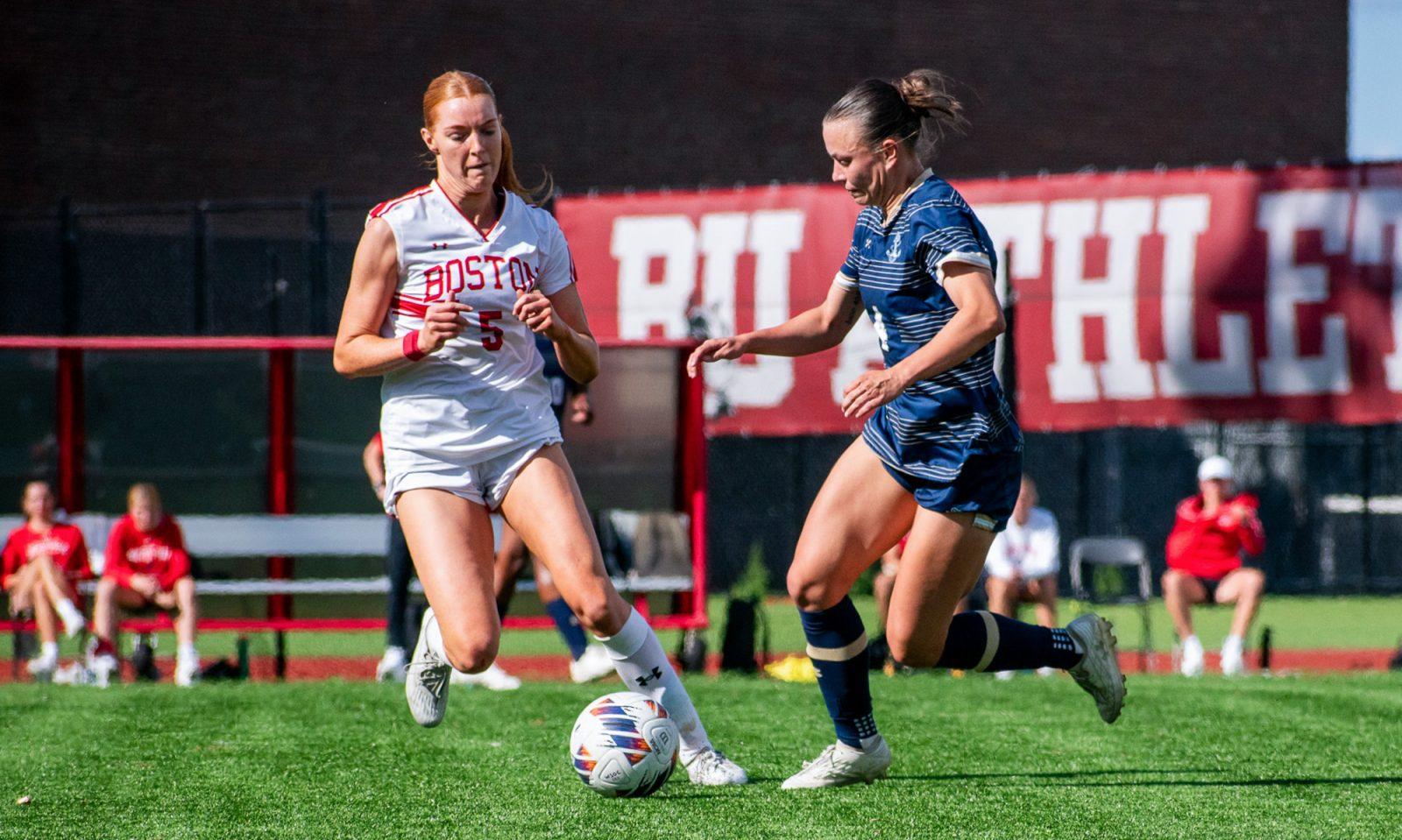 Sophomore midfielder Ciara Kennedy (5) challenges a Navy player for the ball during the women’s soccer game on Saturday. The Terriers tied Navy 1-1 on Saturday and are currently undefeated in Patriot League matches. KELLY BRODER/DFP PHOTOGRAPHER