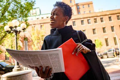 Dr. Melissa Gilliam holds a copy of The Daily Free Press outside of 1 Silber Way.