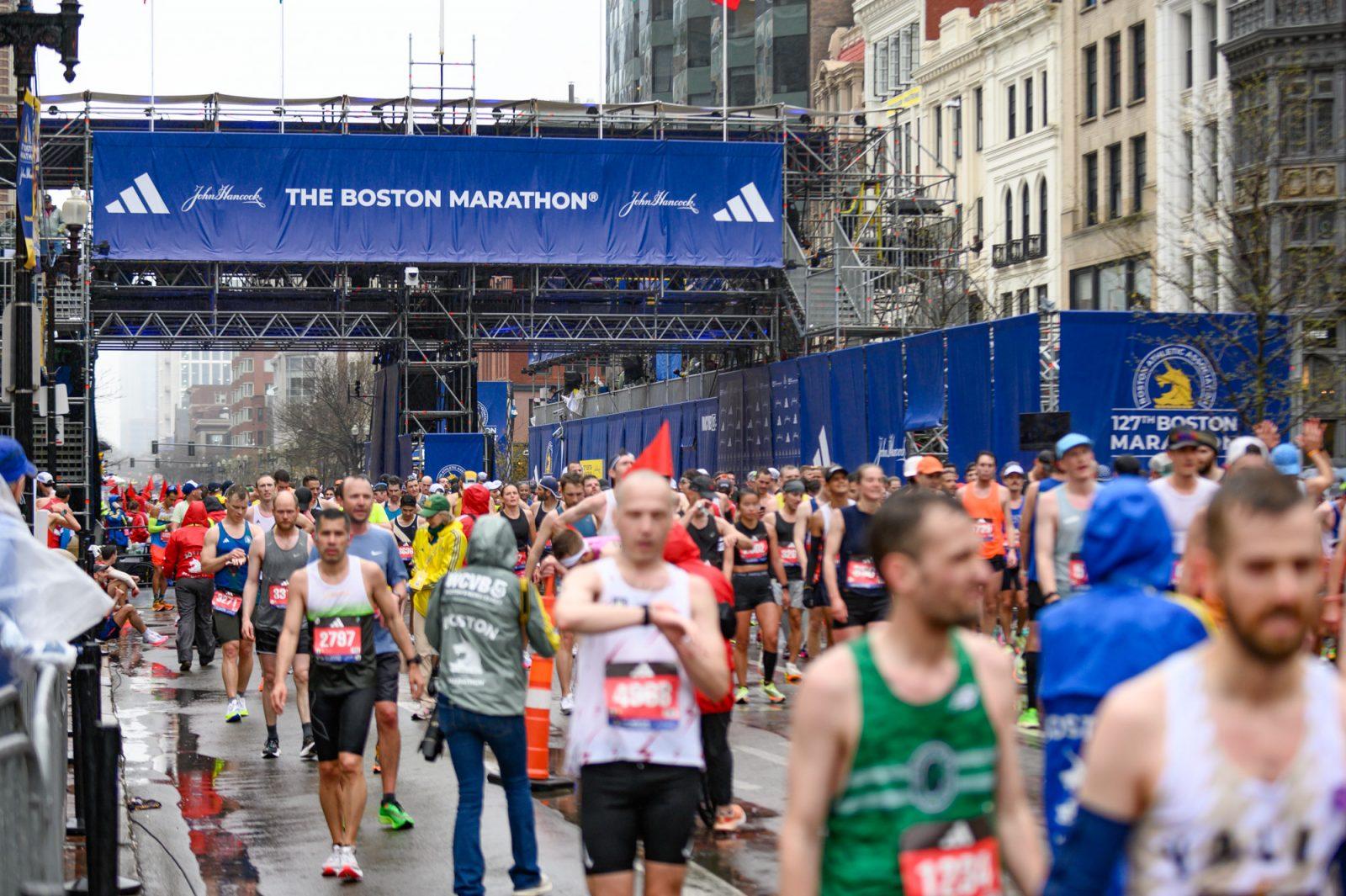 Boston Marathon runners make their way past the finish line in Copley Square in April 2023. Small businesses along the route explained the positive and negative impacts that the marathon can have on operations. ANDREW BURKE-STEVENSON/DFP PHOTOGRAPHER