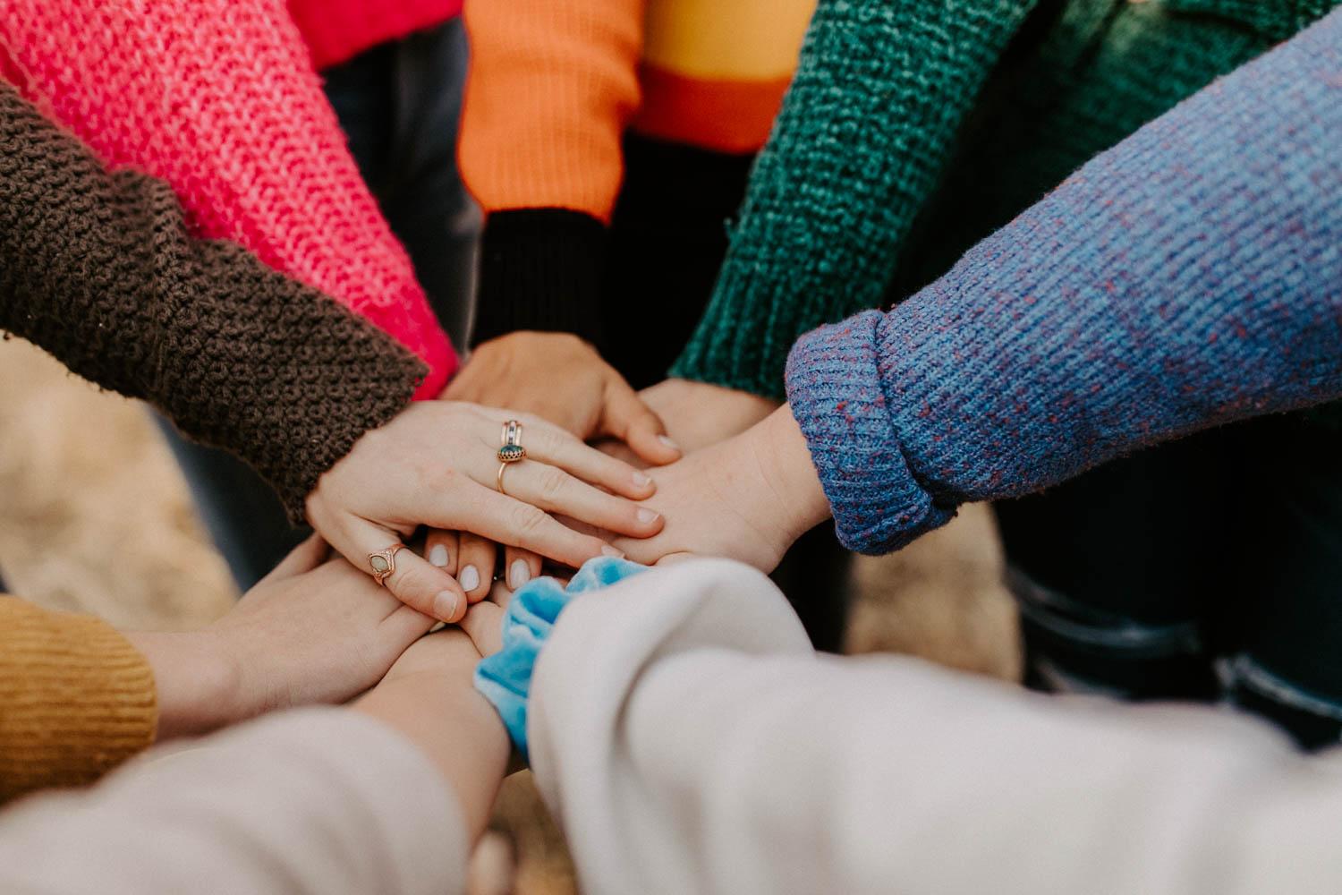 A team hands-in. After trying a variety of extracurricular clubs and groups, Samantha writes about how it was after joining the BU women’s water polo club team that she felt a sense of direction at University.  COURTESY OF HANNAH BUSING VIA UNSPLASH
