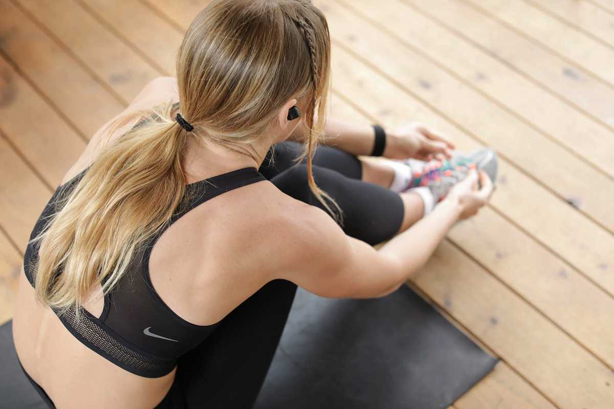 A person wearing earbuds before a workout. From cardio to outdoor walks, Grace Knoop provides tips to cultivating an elite workout playlist. COURTESY OF CALEY VANULAR VIA UNSPLASH