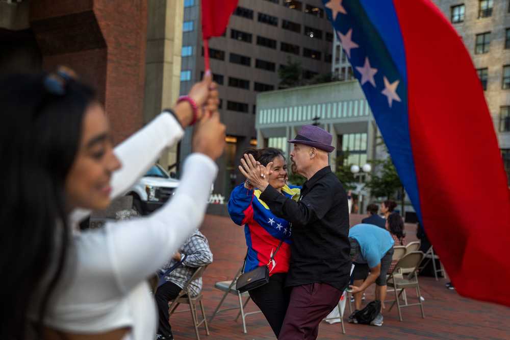 Oveida Davila (center left) and Juan Lopez dance together at the Latinx Heritage Month celebration on Sept. 19 at City Hall Plaza. Mayor Michelle Wu and the Latinx Employee Resource Group put together the event to kick off Heritage Month. TAYLOR COESTER/DFP PHOTOGRAPHER