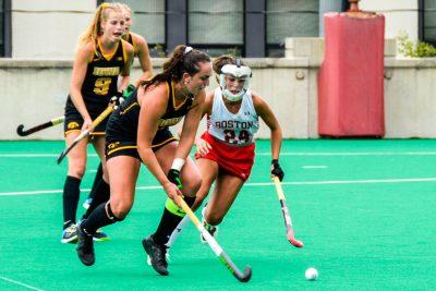 BU field hockey midfielder chasing ball