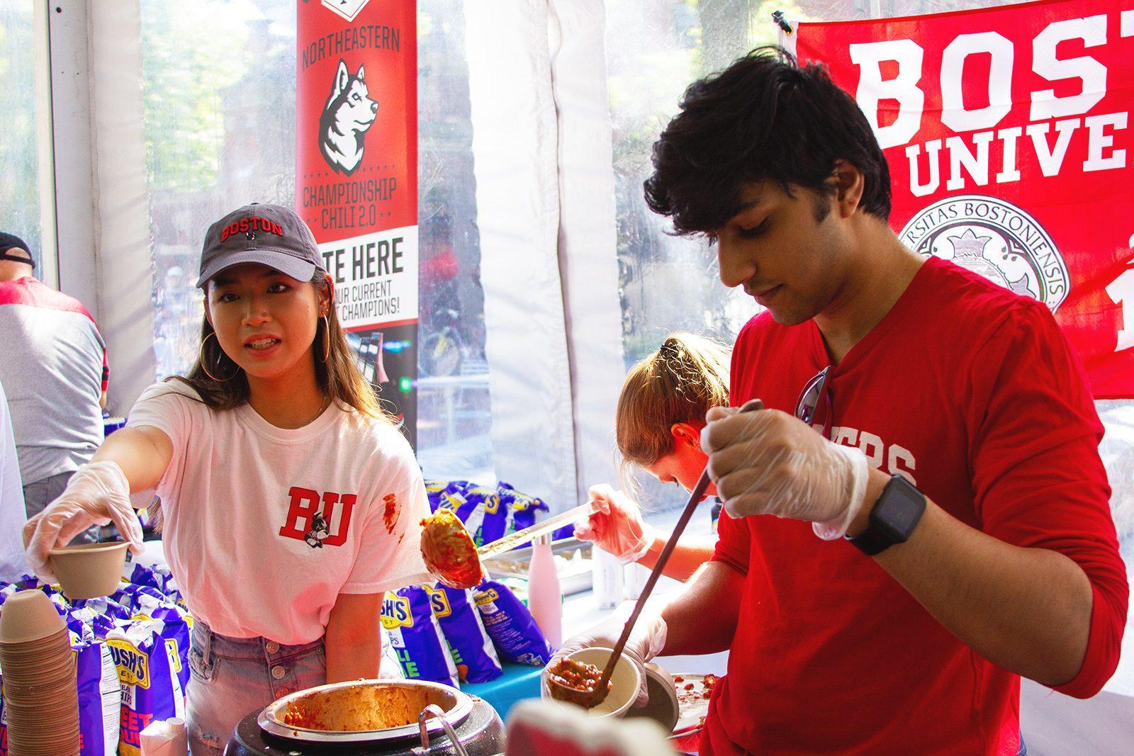 Aditya Jain (ENG '21) and Marlee Feltham (ENG '23) compete in the Vegan Chili Beanpot Festival hosted at Harvard University’s Science Center Plaza Saturday. CONOR KELLEY/ DAILY FREE PRESS STAFF