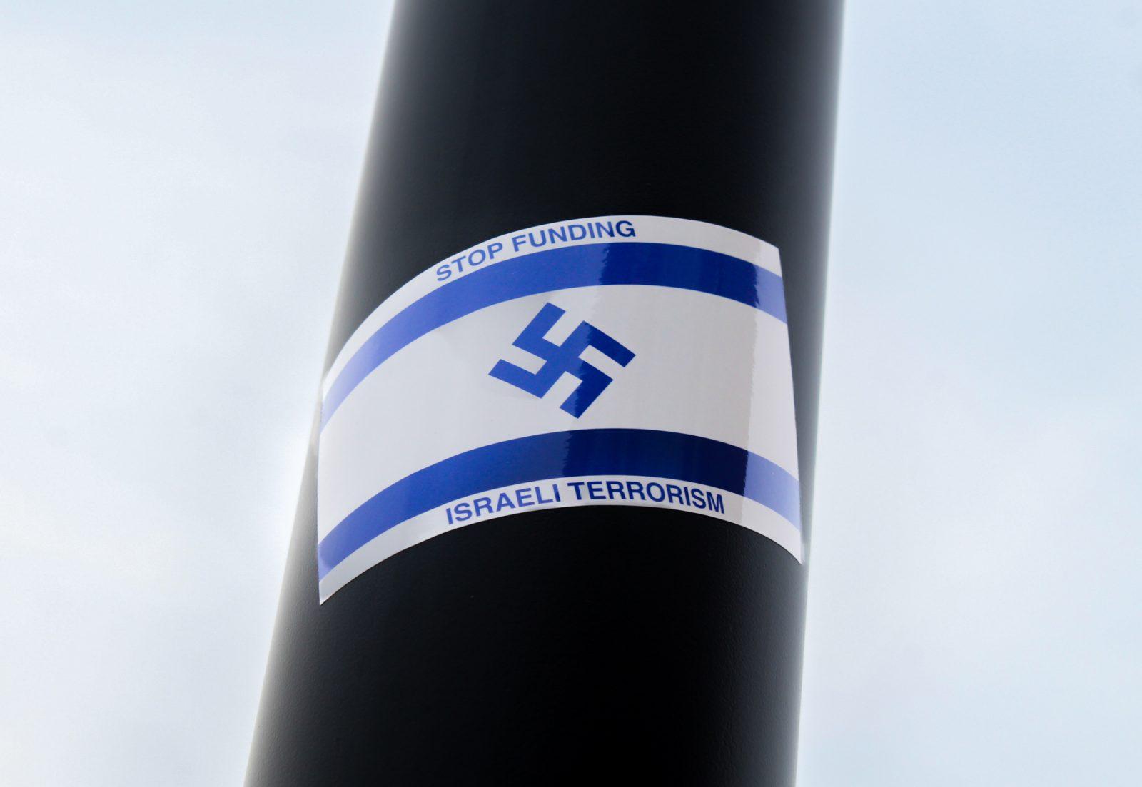 An antisemitic sticker with Nazi signage that says “Stop Funding Israeli Terrorism” stuck on a lamppost at the intersection of Commonwealth Avenue and Harry Agganis Way. Several antisemitic stickers have been spotted on Boston University’s campus this week. SARAH CRUZ/DFP PHOTOGRAPHER