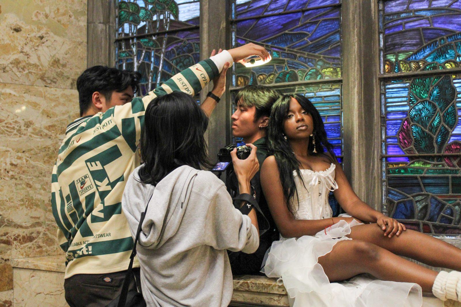 Photographers Parker (left) and Moses (right) taking a picture of models Anthony Alava (left) and Selina Kagume (right) for Bayanihan magazine. The magazine is run by students from Boston University, Suffolk University and Northeastern University in collaboration with the BU Filipino Student Association. SARAH CRUZ/DFP PHOTOGRAPHER 