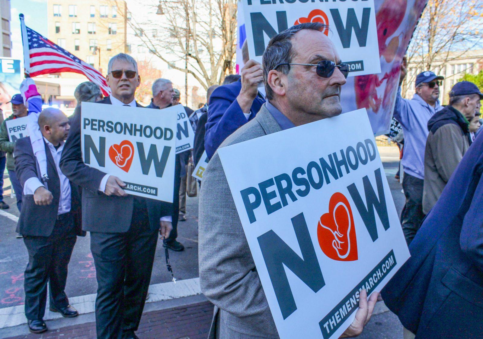 Participants at the third annual Boston Men’s March to Abolish Abortion and Rally for Personhood hold up signs that read, “Personhood Now,” at the rally in Kenmore Square on Saturday. The rally began at the Planned Parenthood on Commonwealth Avenue, and members continued marching through Boston University’s campus until they reached the Boston Common. SARAH CRUZ/DFP PHOTOGRAPHER