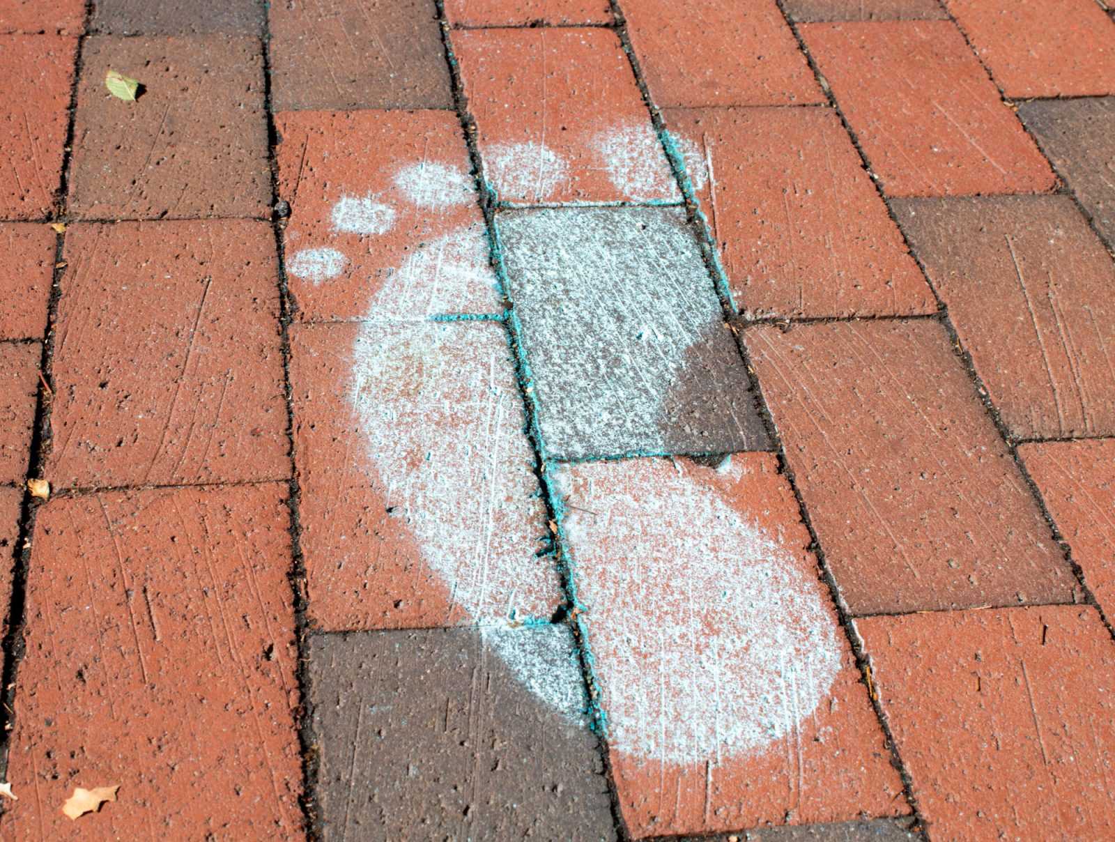 A chalk footprint outside the George Sherman Union. Boston Univeristy’s Sexual Assault Response and Prevention Center created a path of spray paint footprints on Commonwealth Avenue in its new initiative, “I Will Walk with You.” SARAH CRUZ/DFP PHOTOGRAPHER