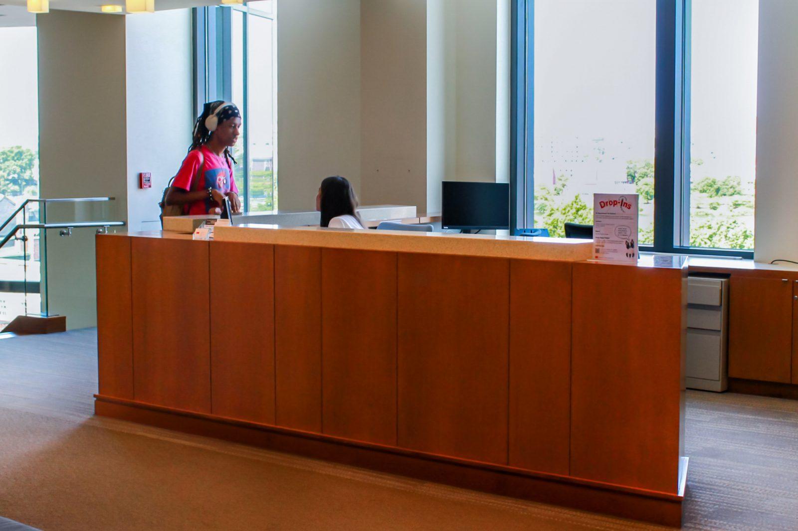 A person speaks with the front desk at the Educational Resource Center in the Center for Career Development building. Many Boston University students have on- or off-campus part-time jobs in addition to being a full-time student. SARAH CRUZ/DFP PHOTOGRAPHER