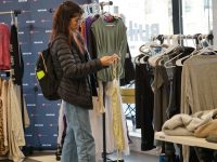 A shopper considers a blouse at Shop Swapp.