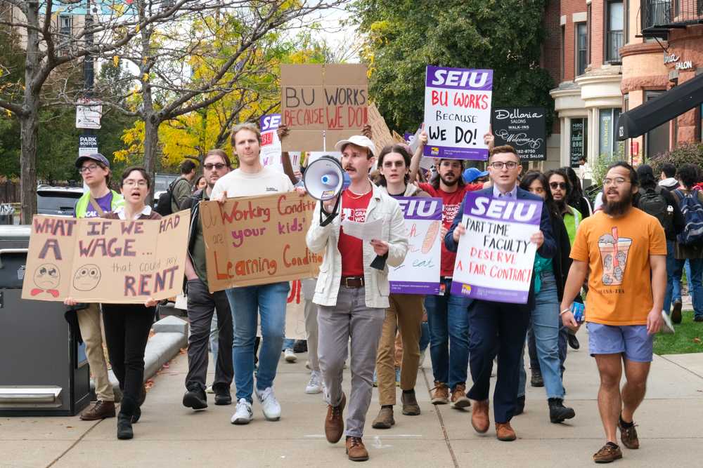 Members of the Boston University graduate, residence life and adjunct faculty unions march down Commonwealth Avenue on Friday. The unions came together in a show of solidarity to express their respective demands. CORINNE DAVIDSON/ DFP PHOTOGRAPHER