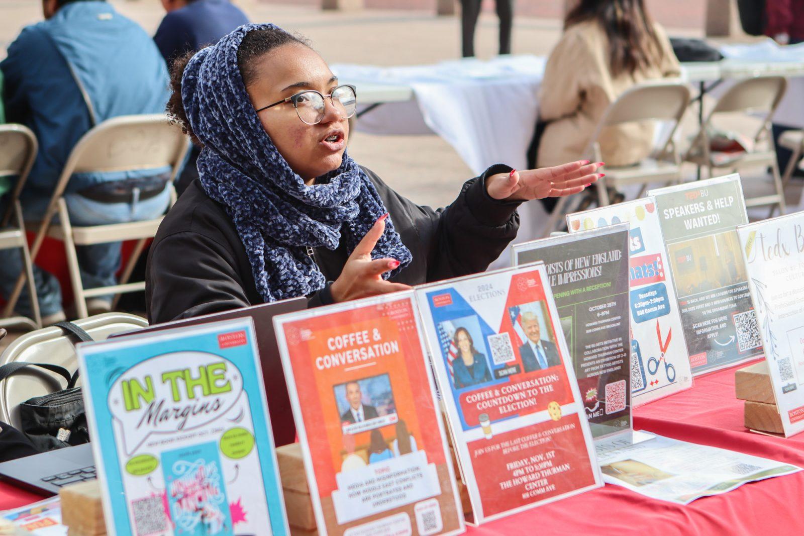 A representative from the Howard Thurman Center informs students about upcoming voting-related events at the BU Votes Civic Engagement Fair on Oct. 15. Boston University Student Government Department of City of Affairs and BU Votes collaborated to create Terrier Turnout, a committee designed to foster civic engagement on campus. RACHEL FEINSTEIN/DFP PHOTOGRAPHER