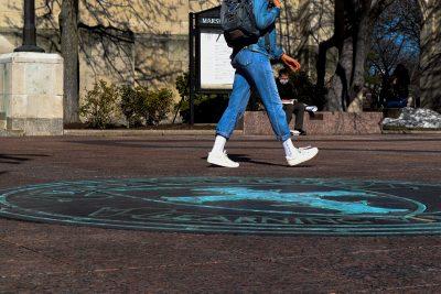 student walking across marsh chapel plaza