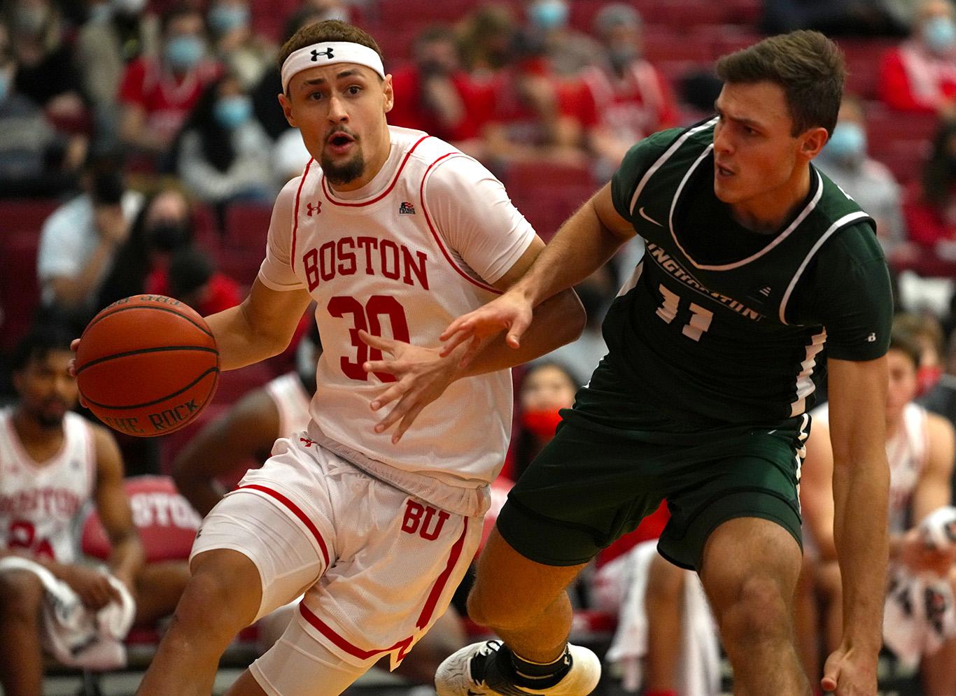 Graduate student guard Javante McCoy dribbles the ball in a basketball match against Binghamton University at Case Gym Saturday. The Terriers defeated the Bearcats 68-63. MOHAN GE/ DFP STAFF
