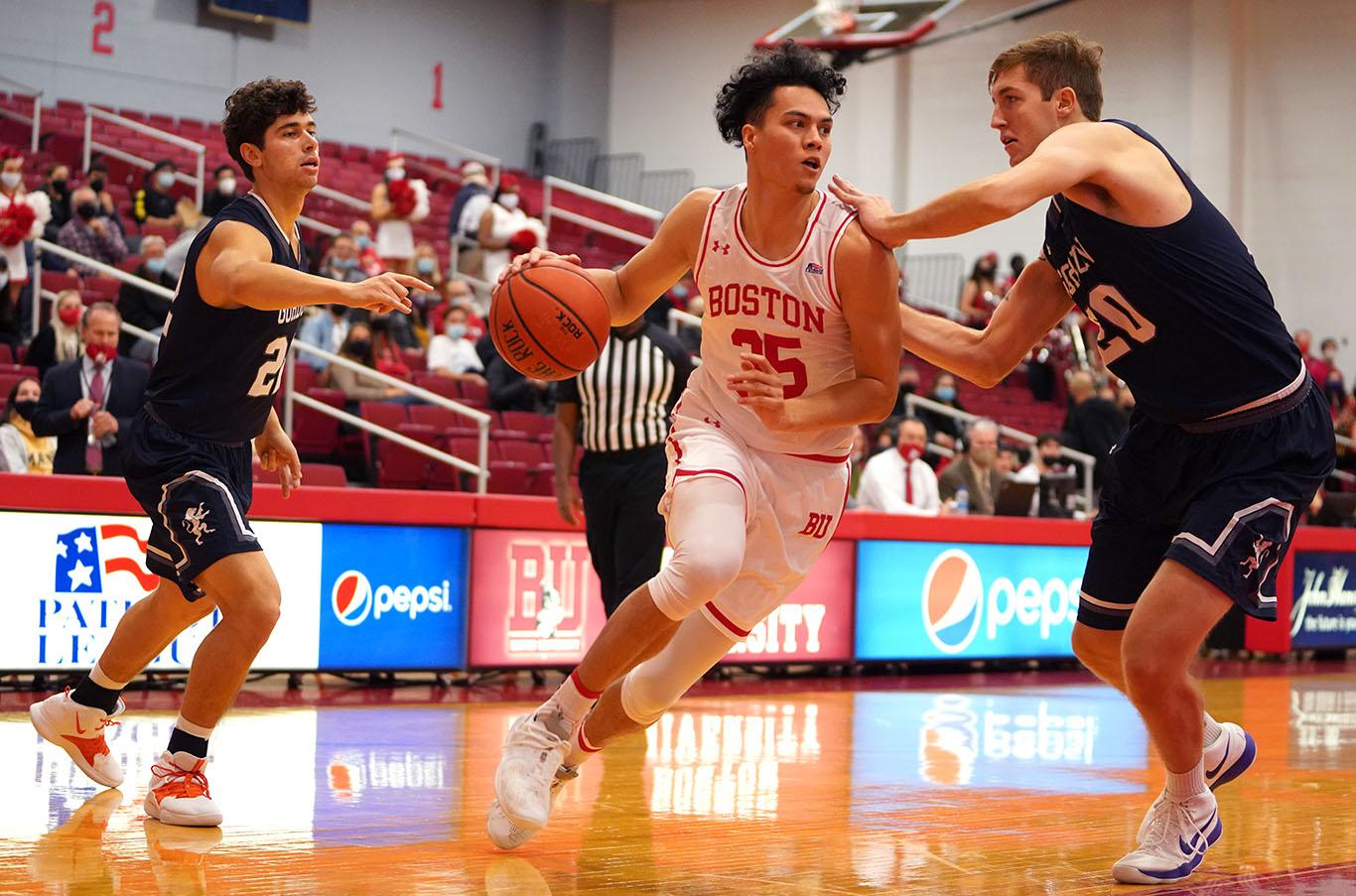 Senior guard Fletcher Tynen running with the ball in a basketball game against Gordon College Friday. The Terriers secured an 85-61 victory over the Fighting Scots in their home opener at Case Gym. MOHAN GE/ DAILY FREE PRESS STAFF
