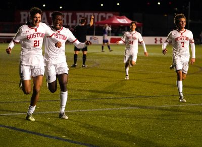 Boston University men’s soccer players cheer after defeating the College of the Holy Cross 3-1 in Nov. 2021.