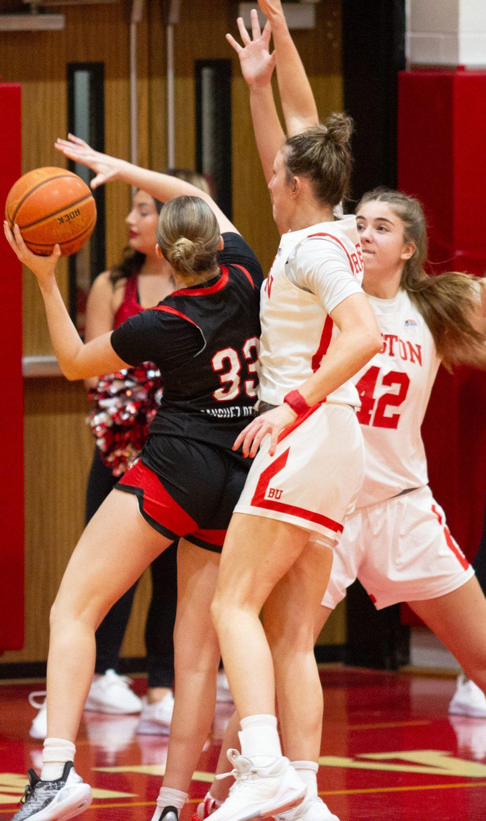 Sophomore guard Audrey Ericksen (21) and freshman forward Allison Schwertner (42) defend a Northeastern player during a game on Nov. 4. The Boston University’s women’s basketball team defeated Holy Cross 52-49 on Monday. CLAIRE GUEST/DFP PHOTOGRAPHER
