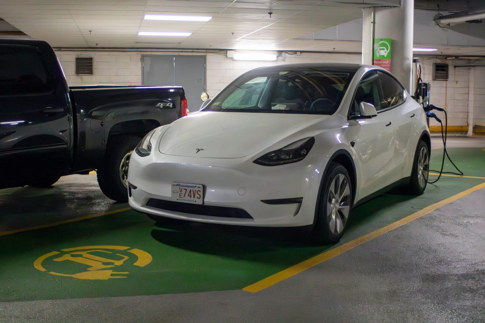 A Tesla using an electric vehicle charging station in the Warren Towers parking garage. EV adoption is lagging, despite promises to revolutionize transportation and move toward a greener future. HOLLY GUSTAVSEN/DFP PHOTOGRAPHER