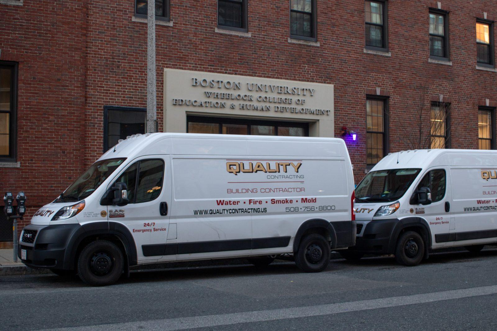 Quality Contracting vans parked outside of Boston University’s Wheelock College of Education and Human Development building. A leak occurred in the fifth floor bathroom of Wheelock on Thursday and forced professors to relocate their Friday classes. HOLLY GUSTAVSEN/DFP PHOTOGRAPHER