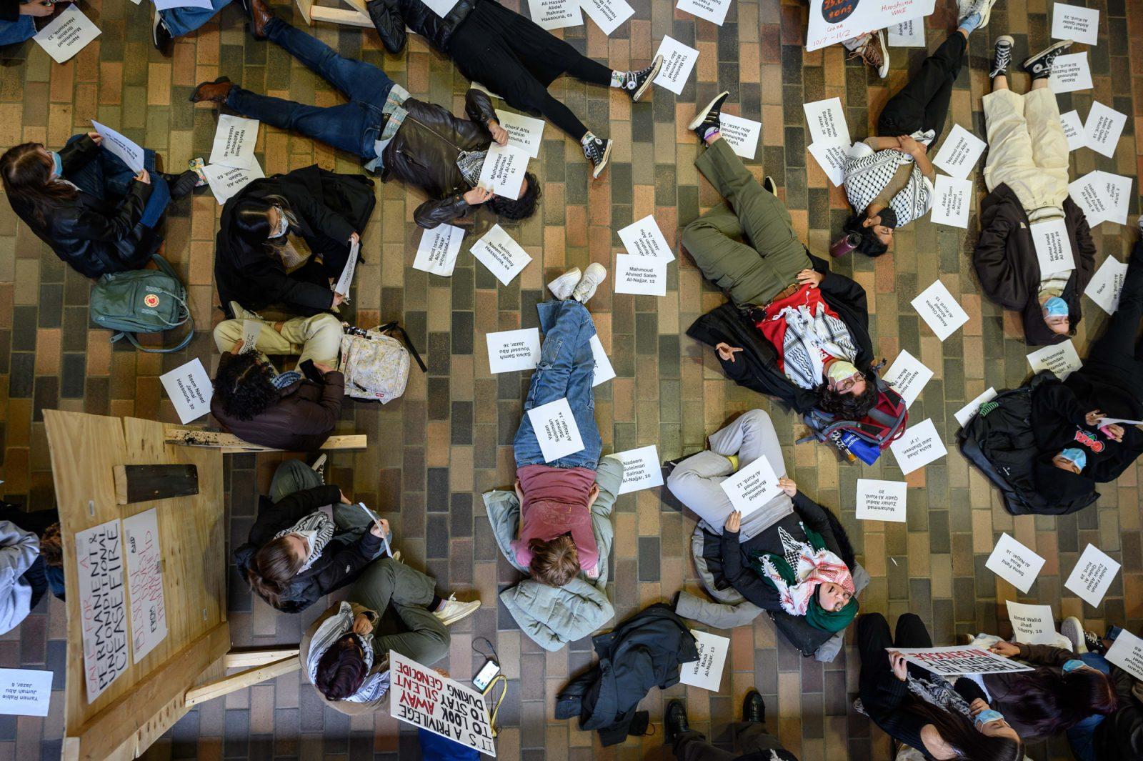 Participants lie on the floor at a die-in protest organized by Students for Justice in Palestine in the George Sherman Union on Dec. 1. ANDREW BURKE-STEVENSON/DFP PHOTOGRAPHER