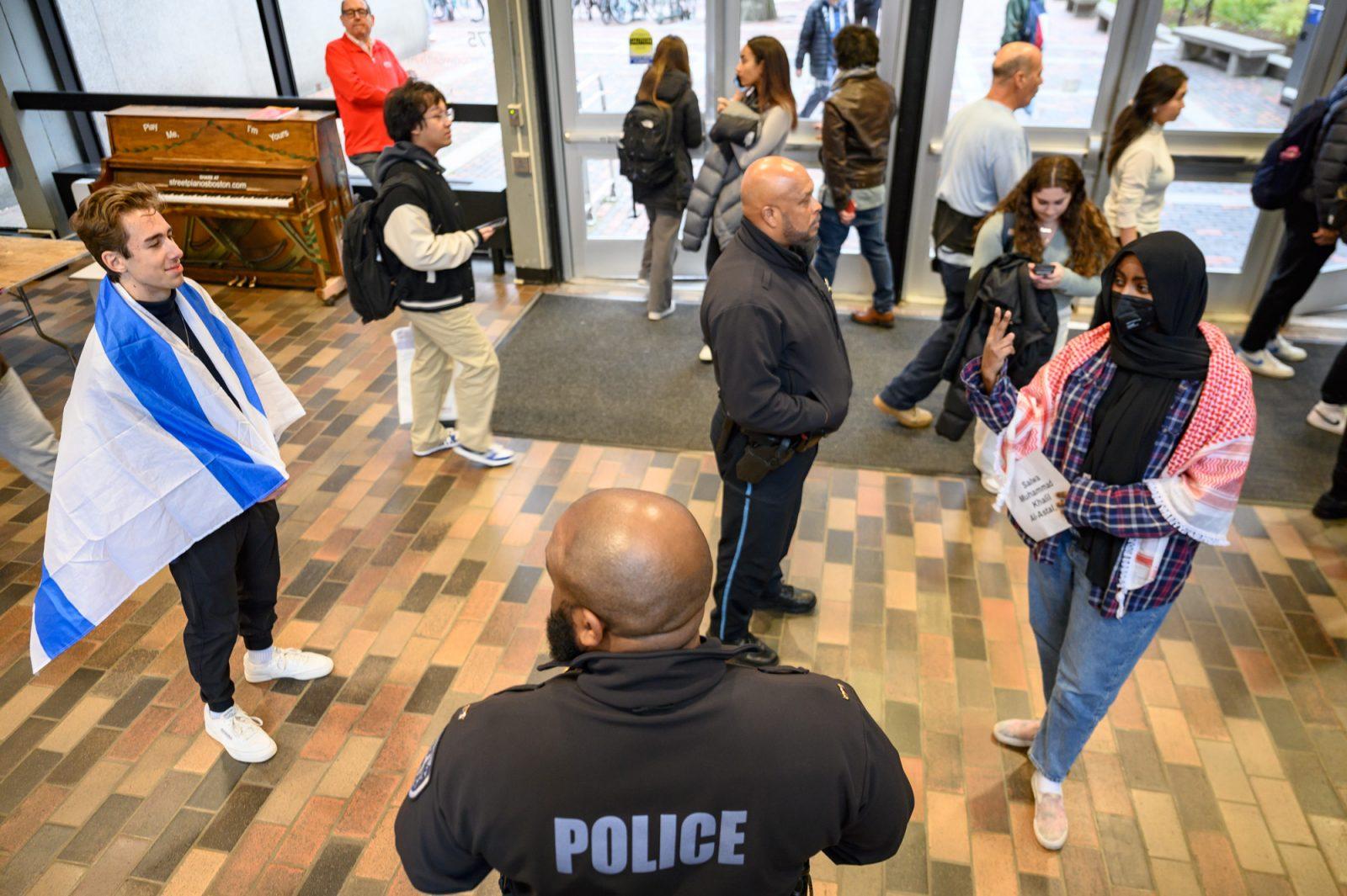 Pro-Israel and pro-Palestine advocates stand across from each other at a die-in protest for Palestine in the George Sherman Union on Dec. 1. Students across Boston said they've had varying experiences with activism for Israel and Palestine. ANDREW BURKE-STEVENSON/DFP PHOTOGRAPHER