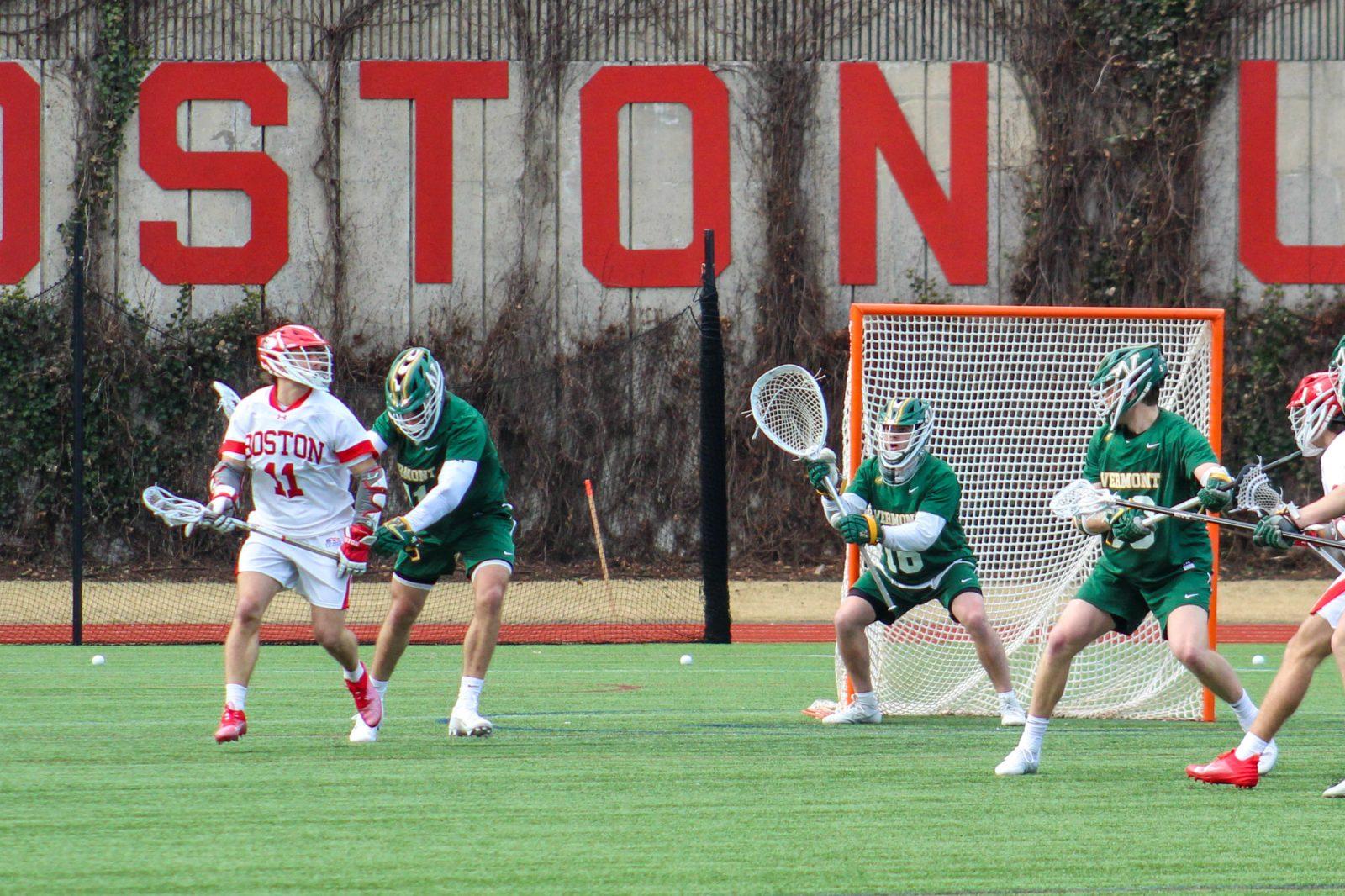 Graduate attacker Vince D'Alto (11) controls the ball in a game against the University of Vermont on Saturday. D'Alto became the program’s all-time leading point producer during the home opener, leading the Terriers to an 18-8 win over the Catamounts. ISABELLA JONES/DFP PHOTOGRAPHER