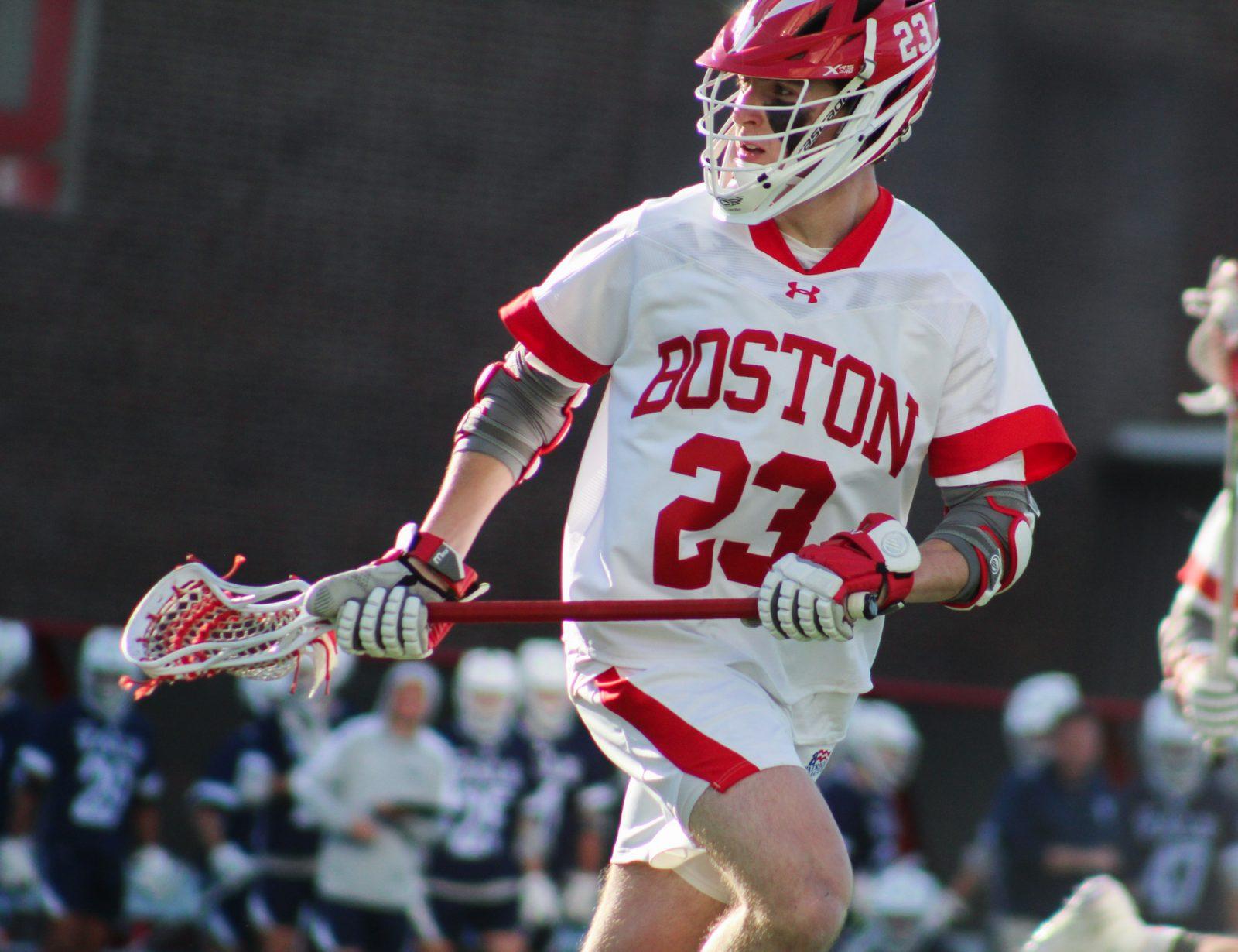 Senior attacking midfielder Tommy Bourque (23) runs down Nickerson Field in a game against Yale University on Tuesday. The Terriers fell to Yale 18-16. BELLA JONES/DFP PHOTOGRAPHER