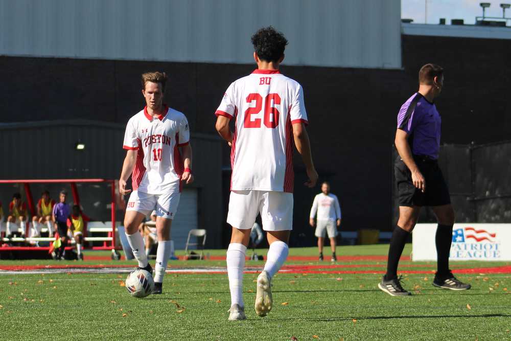 Boston University midfielder graduate student Colin Innes (10) passes the ball to freshman midfielder Jason Zacarias (26) during an Oct. 28 game against Loyola University Maryland