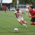 Freshman defender Luke Dunne (32) races towards the ball in a game against Northeastern University on Tuesday