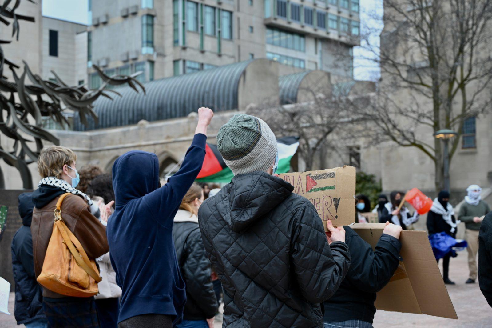 Members of Boston University Students for Justice in Palestine at Marsh Plaza Wednesday. The rally, attended by approximately thirty people, began at Marsh Plaza and moved to the John & Kathryn Silber Administrative Center, where several BU police officers attempted to block participants from entering. JOSIE KALBFLEISCH/DFP PHOTOGRAPHER