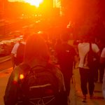 Students walking on Commonwealth Avenue during golden hour