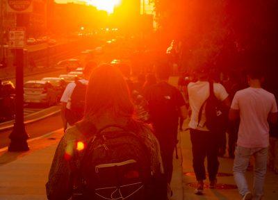 Students walking on Commonwealth Avenue during golden hour