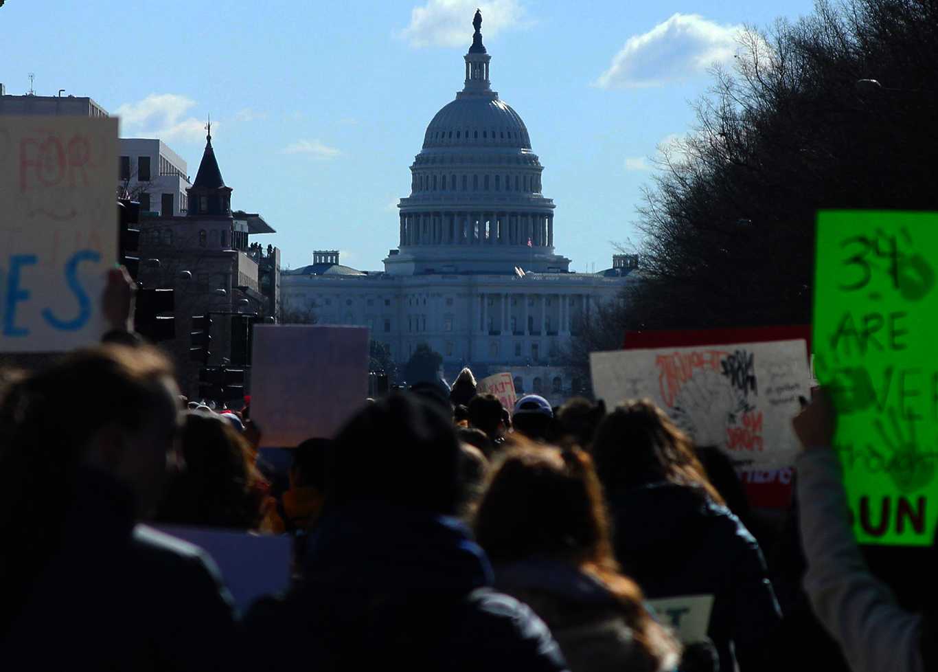 The United States Capitol in view among a crowd of protesters in March 2018. A group of Boston activists is traveling to Washington, D.C. for the Nov. 17 Voting Rights Now! protest to demand action on national voting rights legislation currently in Congressional gridlock. CONOR KELLEY/ DFP FILE
