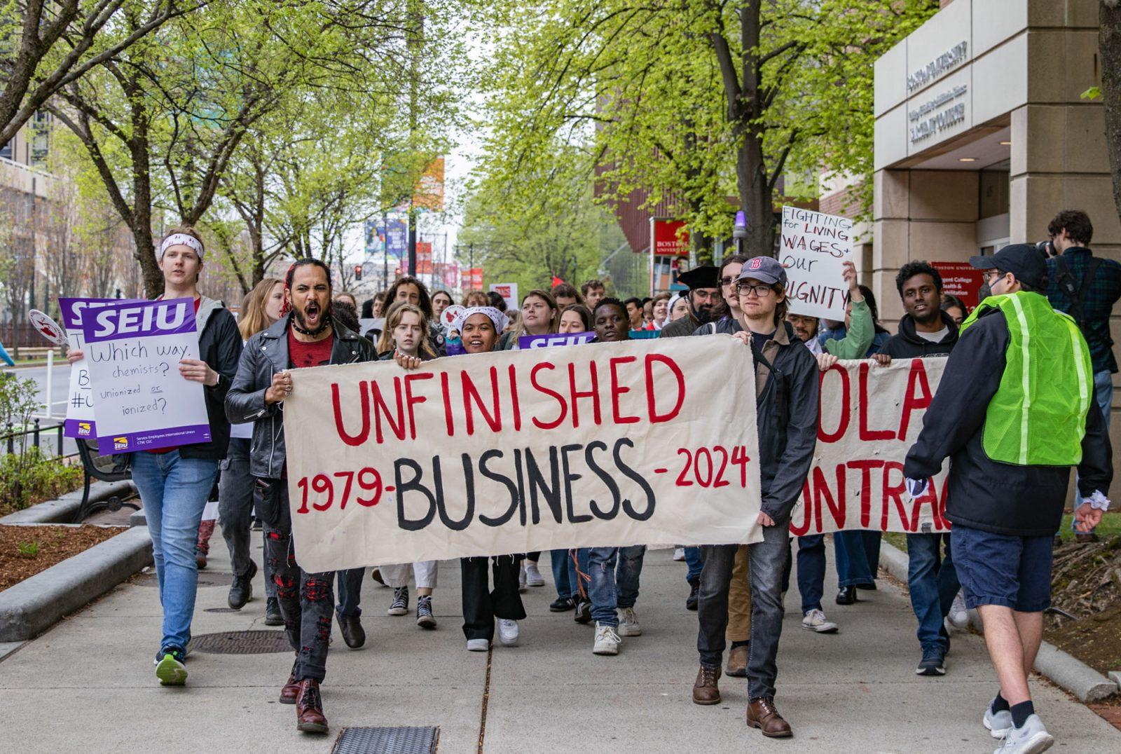 Protestors and members of the Boston University Graduate Workers Union march down Commonwealth Avenue toward 1 Silber Way during a walkout on May 1. BUGWU, which has been on strike since March 25, demands higher waves, comprehensive healthcare, childcare funding and workload protections from the University’s administration. KATE KOTLYAR/DFP PHOTOGRAPHER