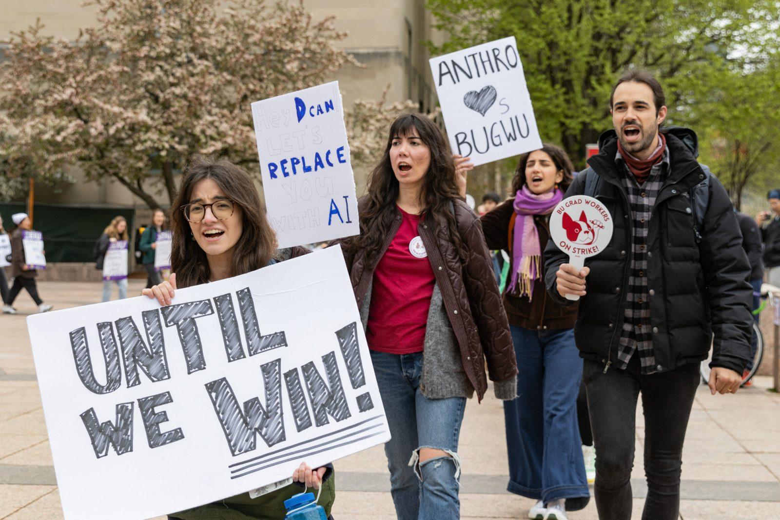 Protestors walk around Marsh Plaza with signs before the walkout on Wednesday. KATE KOTLYAR/DFP PHOTOGRAPHER