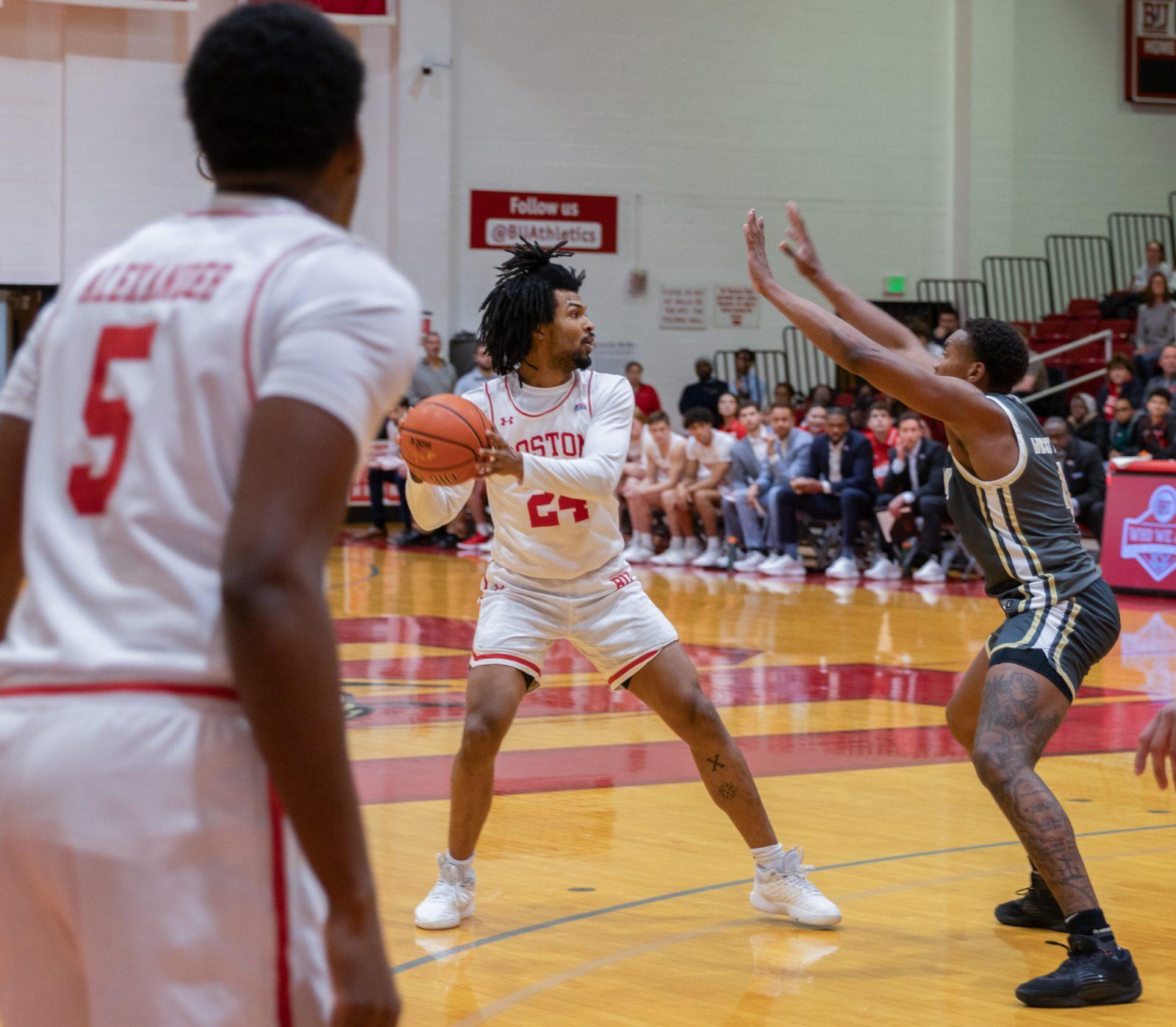 Senior guard Miles Brewster (24) looks to pass the ball in a game against Army West Point on Jan. 24. The Terriers won 62-48 against Lafayette College on Saturday. KATE KOTLYAR/DFP PHOTOGRAPHER