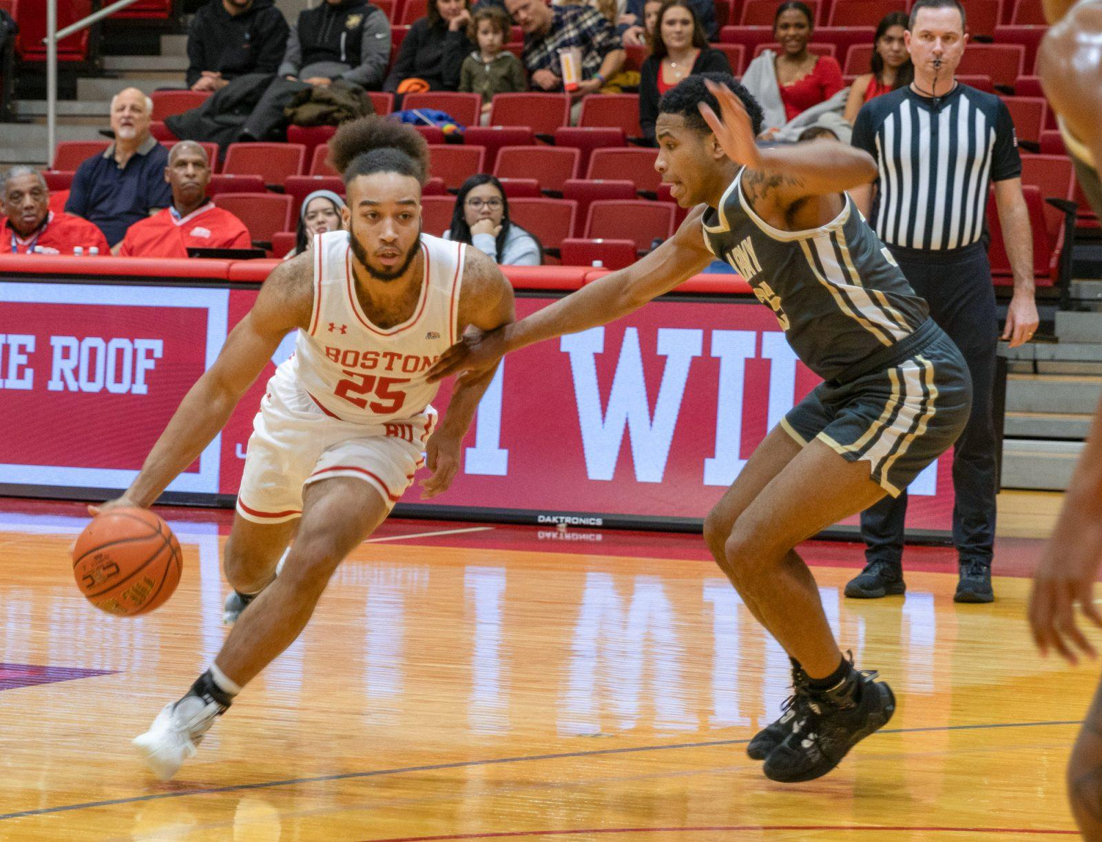 Freshman guard Spencer Joyner (25) drives toward the basket in a game against Army on Jan. 24. The Terriers swept American in the second game of their series this season, winning 67-52 on Wednesday. KATE KOTLYAR/ DFP PHOTOGRAPHER