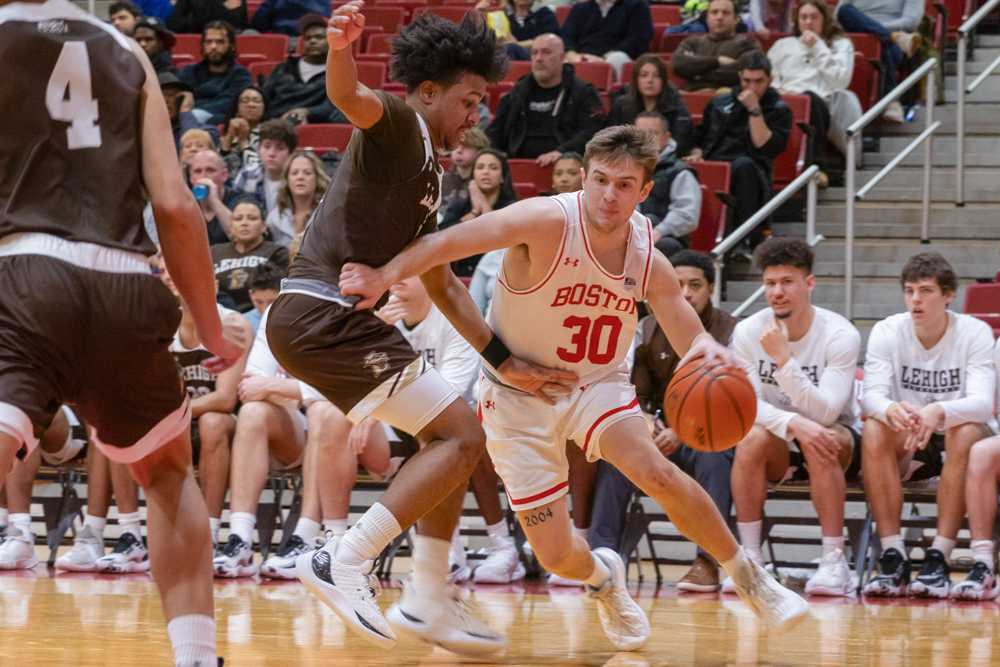 Then-sophomore guard Ben Roy (30) runs toward the basket in a game against Lehigh University on Feb. 4. The BU men’s basketball team will play their first game of the season on Nov. 4 against Northeastern University. KATE KOTLYAR/DFP PHOTOGRAPHER.
