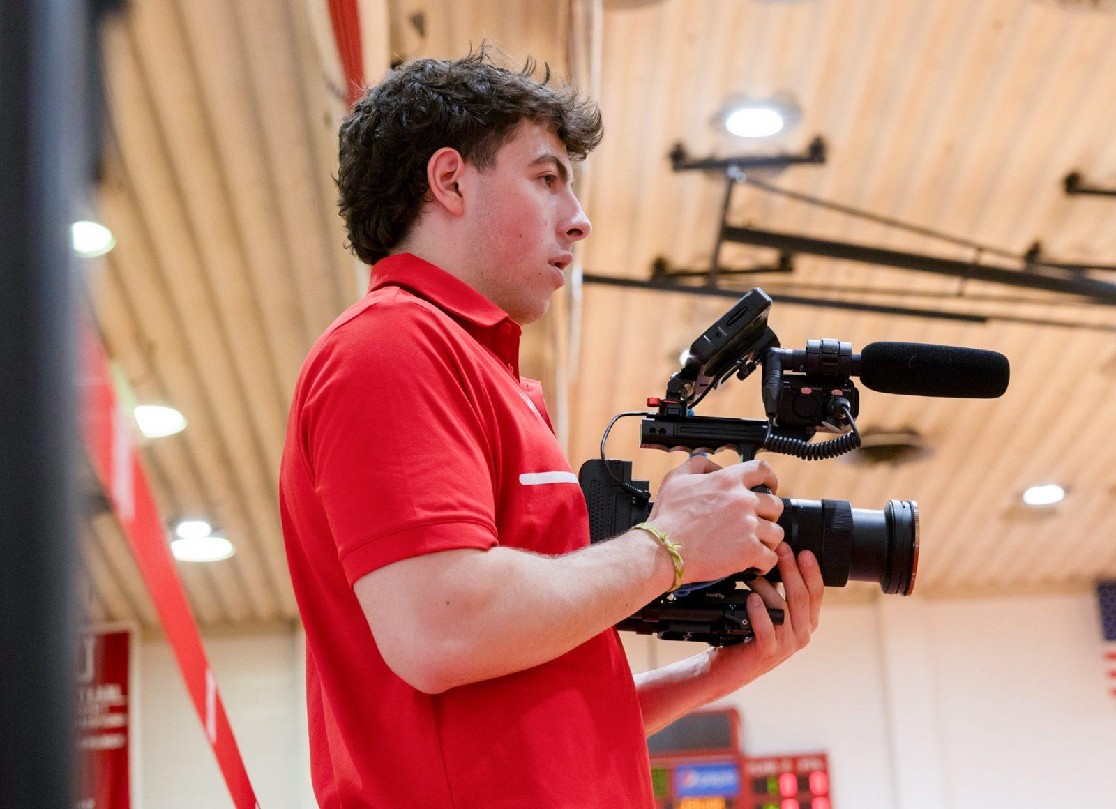 Taub films a men’s basketball game in Boston University’s Case Gym. KATE KOTLYAR/DFP PHOTOGRAPHER